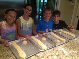 Nicole, her brother and friends baking challahs